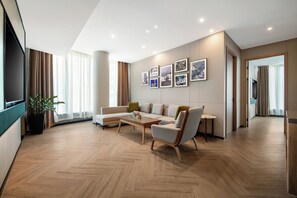 Suite, 2 Bedrooms | Living area | 50-inch flat-screen TV with cable channels, TV, pay movies