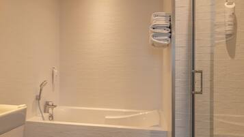 Driepersoonskamer | Badkamer | Een douche, een haardroger, handdoeken