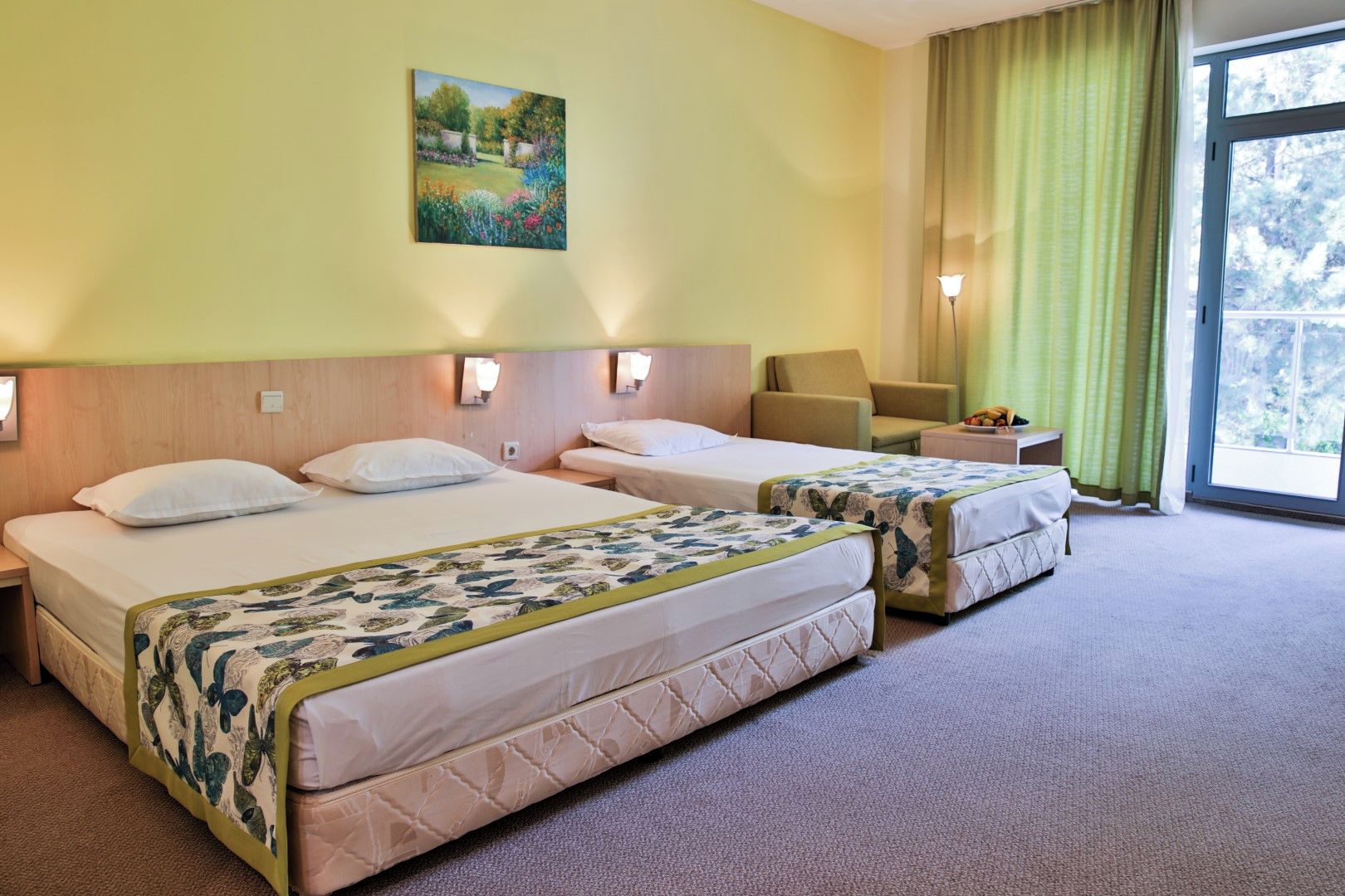 A hotel room with two beds, a painting on the wall, a chair, and a window with curtains.