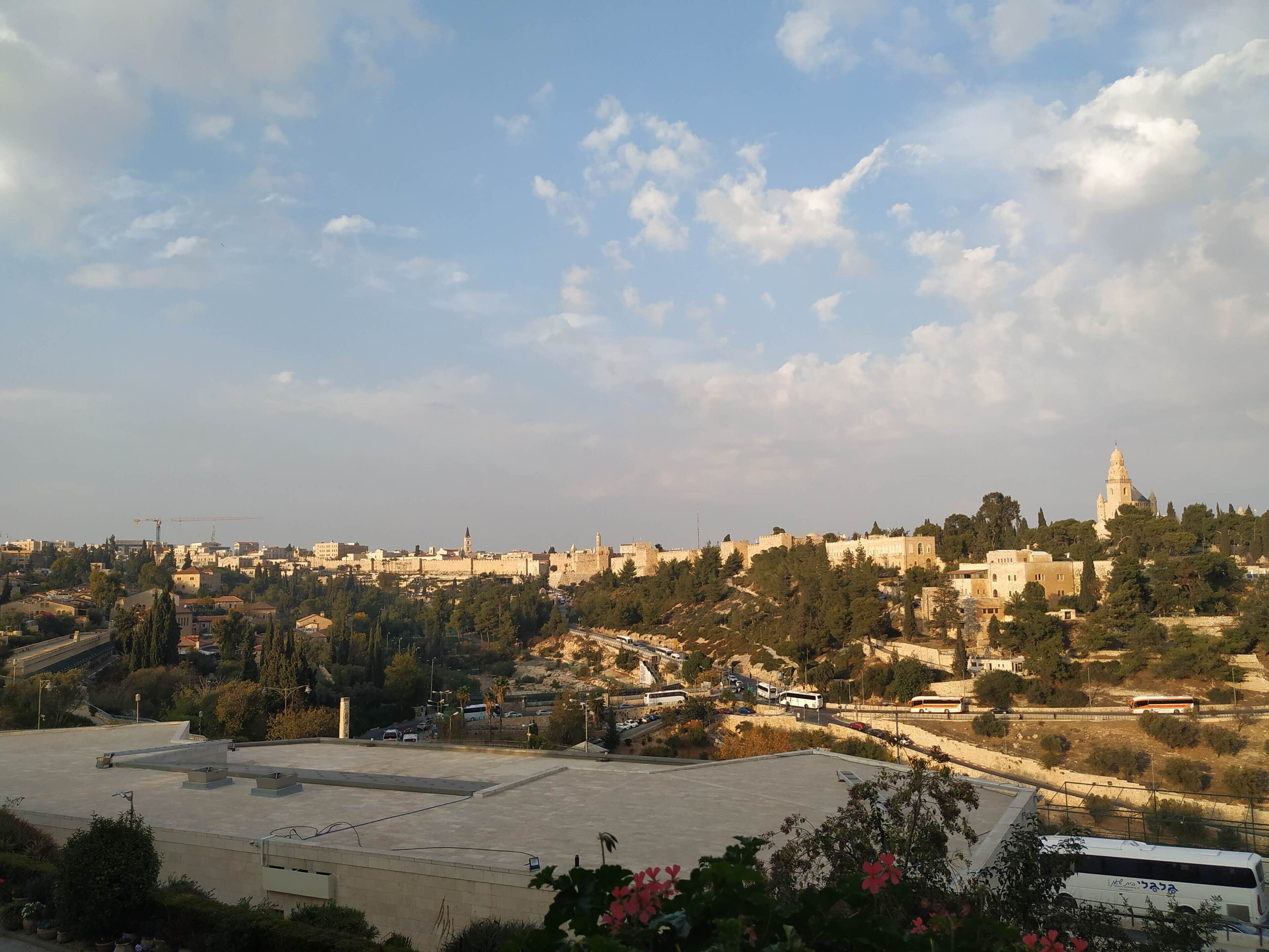 A cityscape with historical buildings, a prominent dome structure, and a mix of residential and commercial buildings.