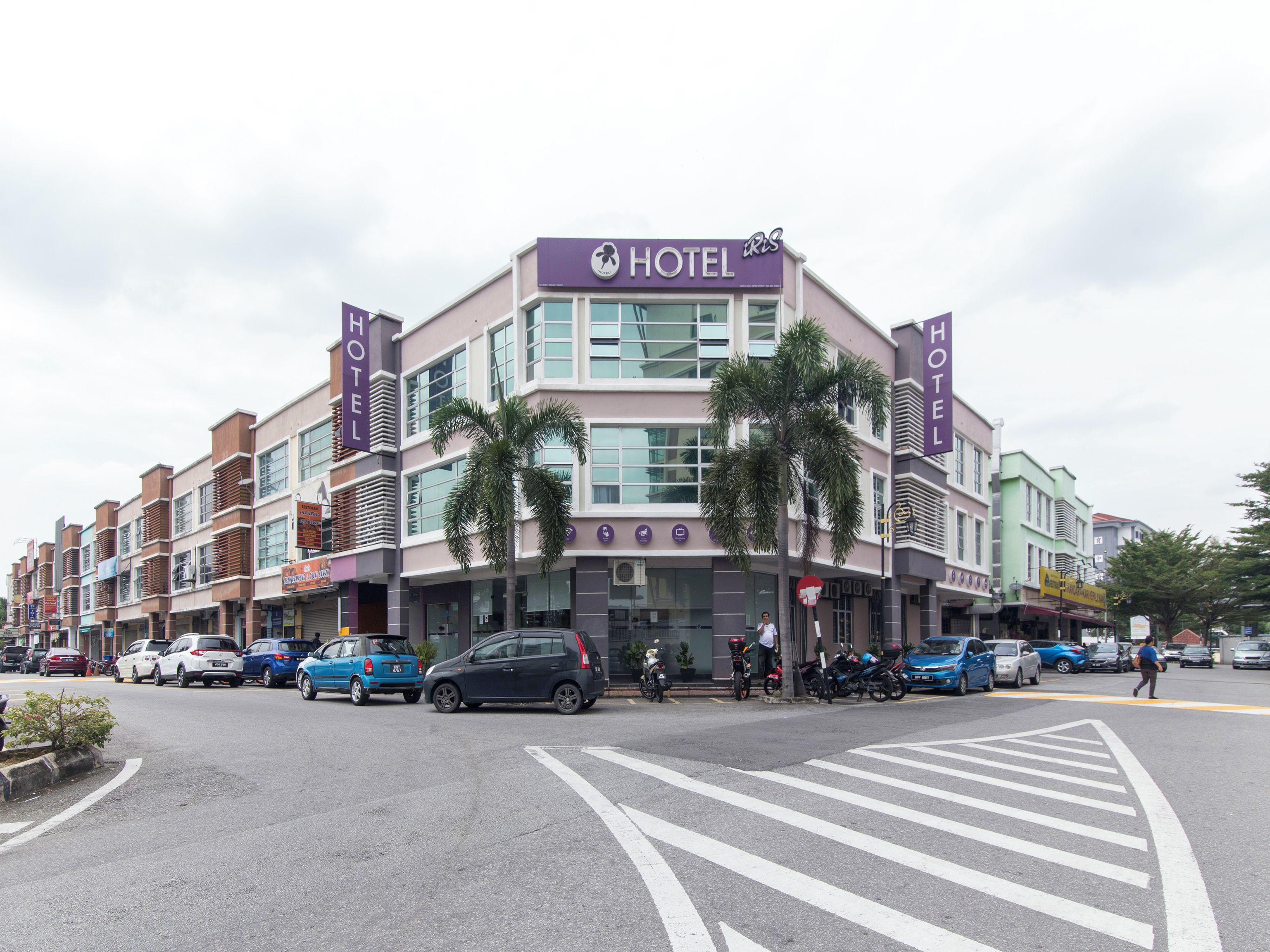 A hotel with a modern facade, multiple floors, and a prominent sign.