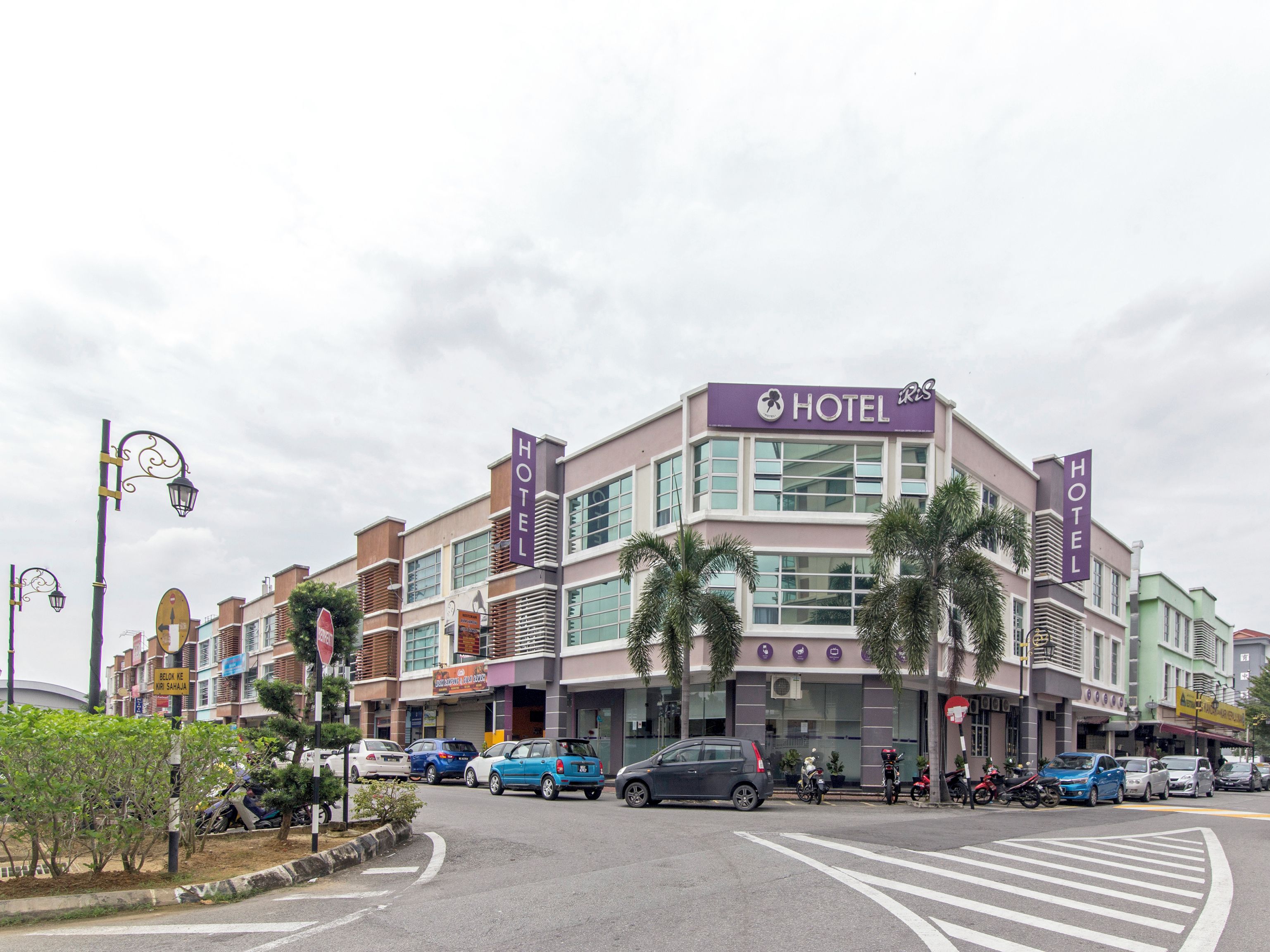 A hotel with a modern facade, multiple floors, and a prominent 'HOTEL' sign.