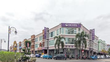 A hotel with a modern facade, multiple floors, and a prominent 'HOTEL' sign.