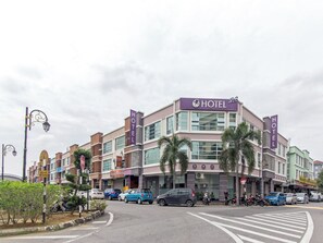 A hotel with a modern facade, multiple floors, and a prominent 'HOTEL' sign. - Iris Hotel (Kajang)