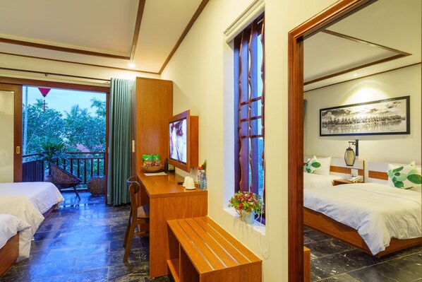 A hotel room with two beds, a desk, a chair, a window with curtains, a TV, and a painting on the wall. - CIC Hoi An Villa (Da Nang)