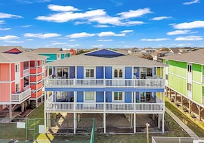 A multi-story building with balconies, a covered outdoor area, and a view of the surrounding neighborhood. - Seven Seas-7c 2 Bedroom Home by RedAwning (Supply)