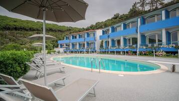 Seasonal outdoor pool, open 8:00 AM to 9:00 PM, pool umbrellas