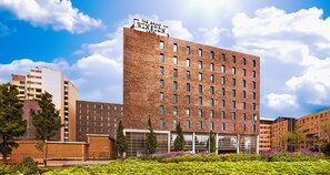 A multi-story building with a prominent sign reading "The Brand Winston Hotel." - PLAZA Premium Grand Winston (Rijswijk)