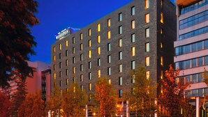 A multi-story hotel with a prominent sign reading "The Grand Winston Hotel". - PLAZA Premium Grand Winston (Rijswijk)