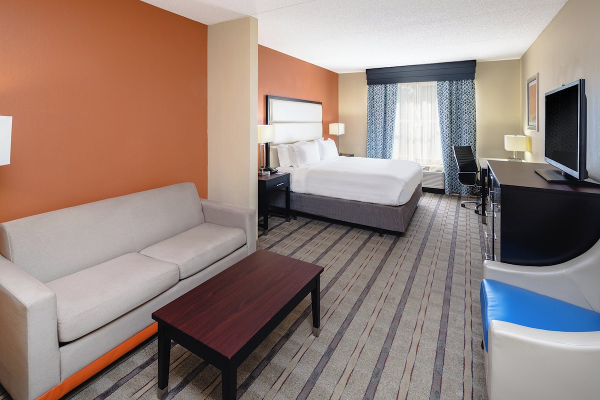 Premium bedding, desk, laptop workspace, blackout drapes