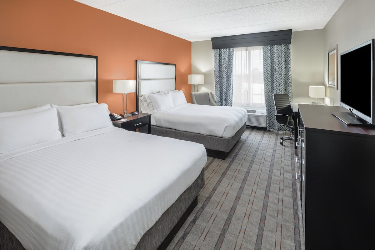 Premium bedding, desk, laptop workspace, blackout drapes