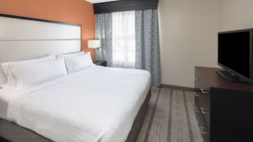 Premium bedding, desk, laptop workspace, blackout drapes