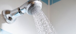 A showerhead with water flowing from it.