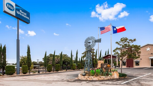 A Best Western hotel entrance with a windmill, American and Texas flags, and a star on the building. - Best Western Johnson City Inn (Johnson City)
