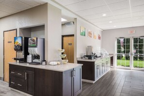 A modern coffee station with espresso machines and a self-serve coffee dispenser.