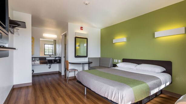 A hotel room with a bed, a desk, a chair, and a bathroom. - Motel 6 El Paso, TX - East (El Paso)