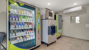 A vending machine with a variety of drinks and a refrigerator. - Motel 6 Venice, FL (Venice)