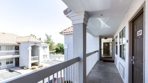 A hotel corridor with a balcony, a door marked 269, and a clear view of the street. - Studio 6 Tempe, AZ (Tempe)