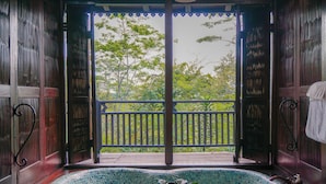 A room with a view of a wooden deck and trees. - MesaStila Resort and Spa (Pringsurat)