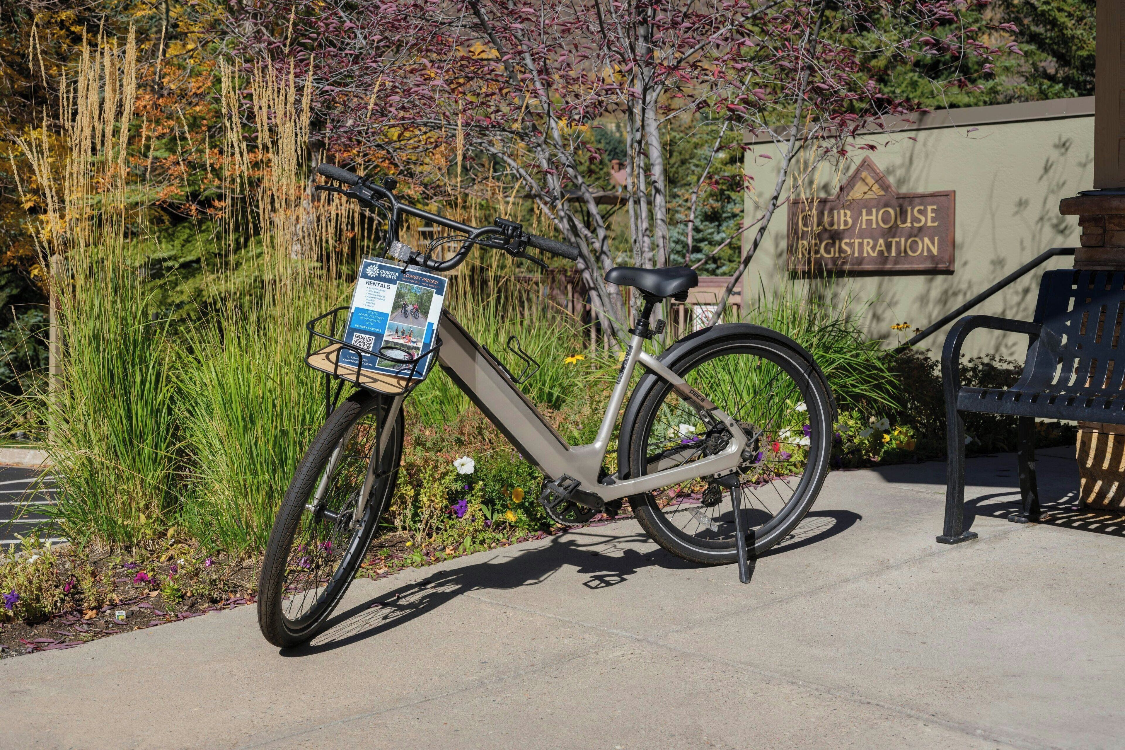 A bicycle parked next to a sign that reads "CLUB HOUSE REGISTRATION".