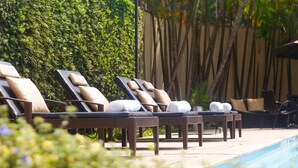 A poolside area with lounge chairs and towels.