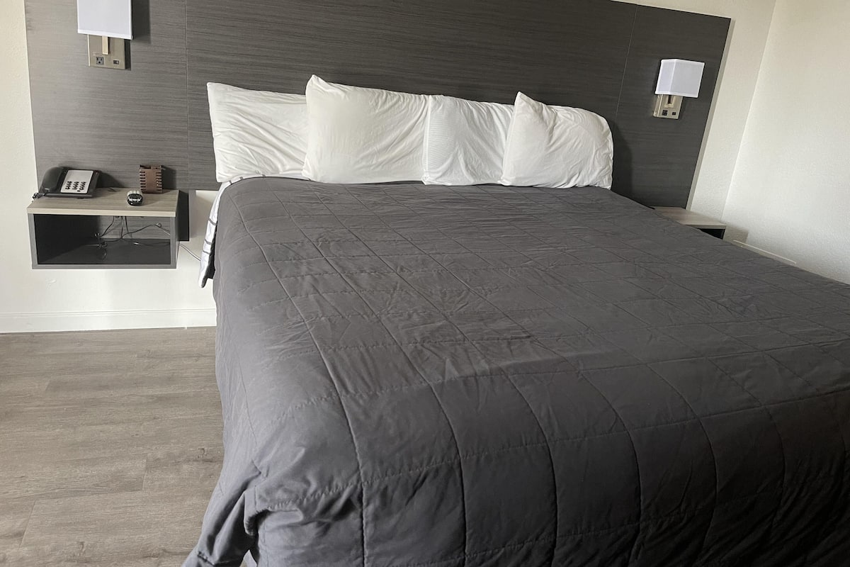 Escritorio, cortinas blackout y tabla de planchar con plancha