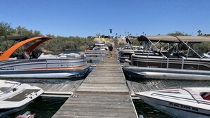 A marina with several boats docked at wooden piers.