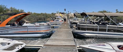 A marina with several boats docked at wooden piers.