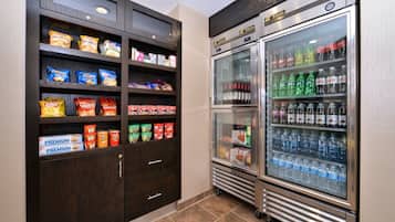 A snack and beverage refrigerator with various snacks and drinks.