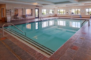 An indoor swimming pool with clear water, surrounded by a tiled floor and walls. - Holiday Inn Express Hotel & Suites Kingman by IHG (Kingman)