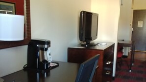 A hotel room with a desk, a coffee maker, a television, and a chair. - Holiday Inn Express Hotel & Suites Kingman by IHG (Kingman)