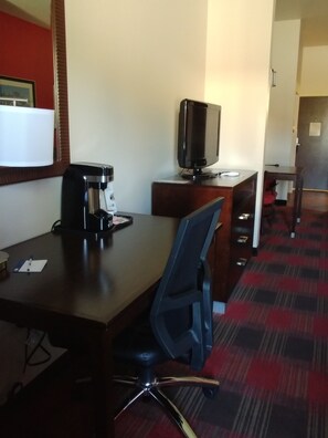 A hotel room with a desk, a coffee maker, a television, and a chair. - Holiday Inn Express Hotel & Suites Kingman by IHG (Kingman)
