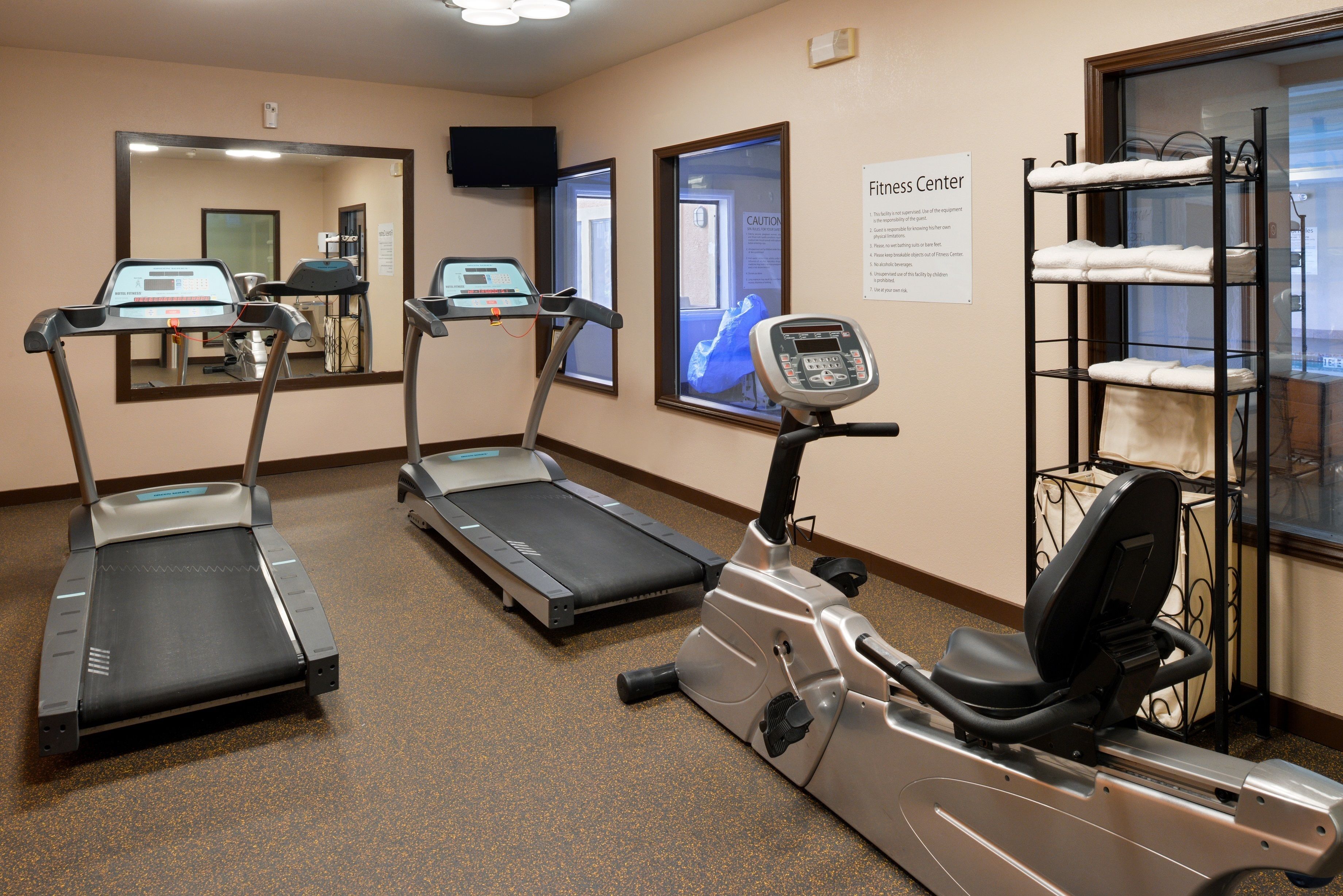A fitness center with treadmills, an elliptical, and a stationary bike.