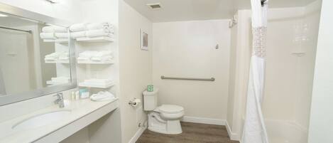 A bathroom with a toilet, sink, and shower.