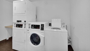A laundry area with stacked washer and dryer units.