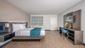 A modern hotel room with a bed, a desk, a chair, and a television. - Motel 6 Euless, TX - Dallas (Euless)