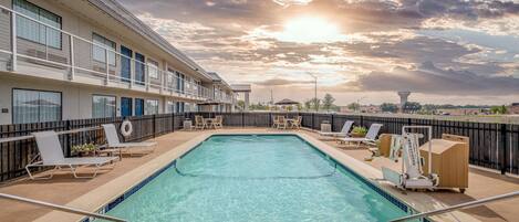 Seasonal outdoor pool, open 9:00 AM to 9:00 PM, pool umbrellas