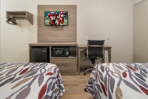 A hotel room with two beds, a desk with a chair, a television mounted on the wall, a microwave, and a small storage cabinet. - Red Roof Inn Fort Worth South (Fort Worth)