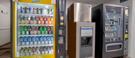 Three Snapple vending machines in a hallway.