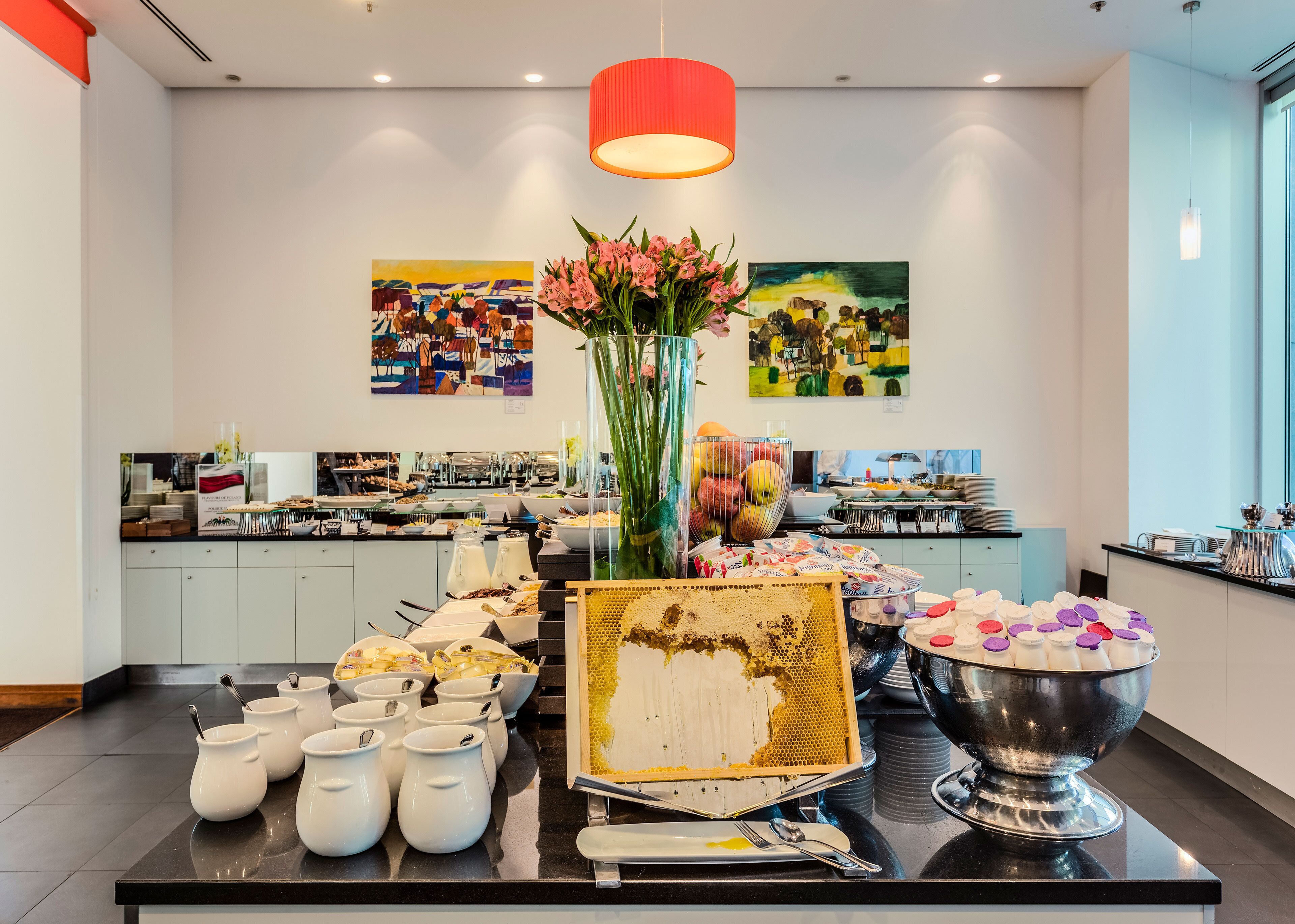 A buffet setup with various food items and a honeycomb centerpiece.