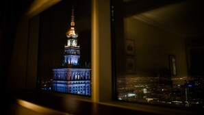 A nighttime view of a cityscape with a prominent illuminated tower. - InterContinental Warsaw by IHG (Warsaw)