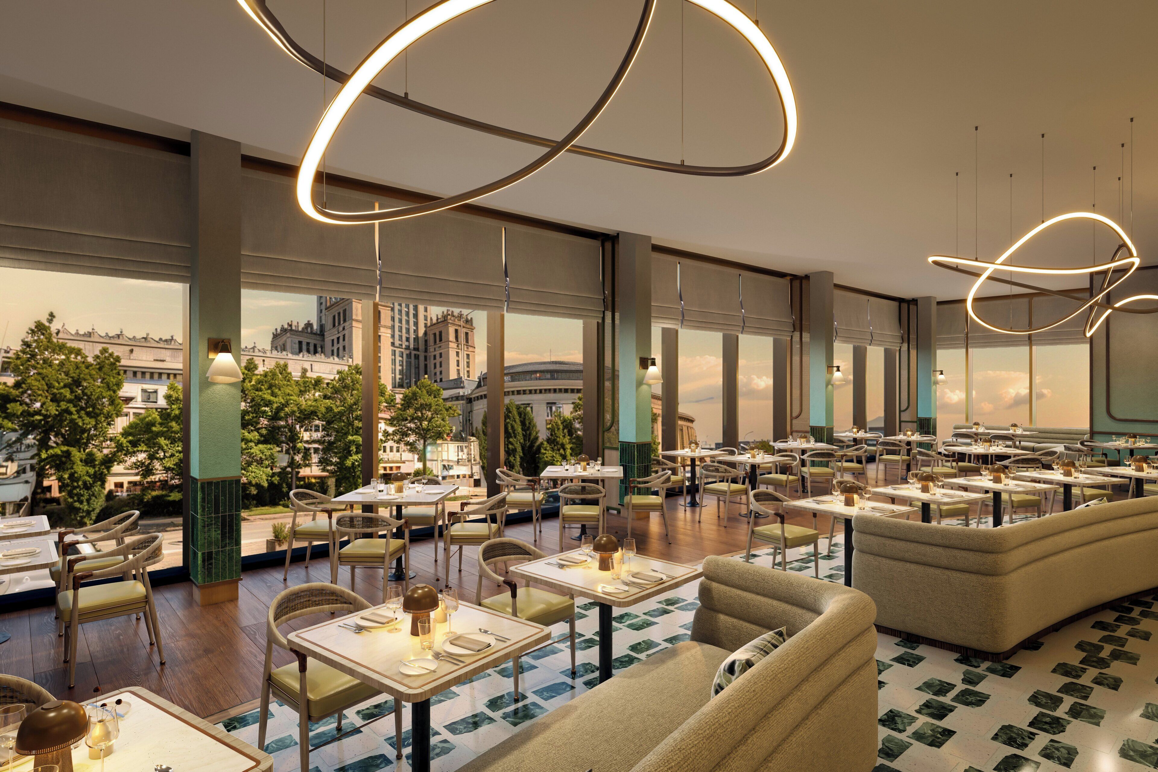 A spacious restaurant with multiple dining tables and chairs, large windows offering city views, and modern lighting fixtures.