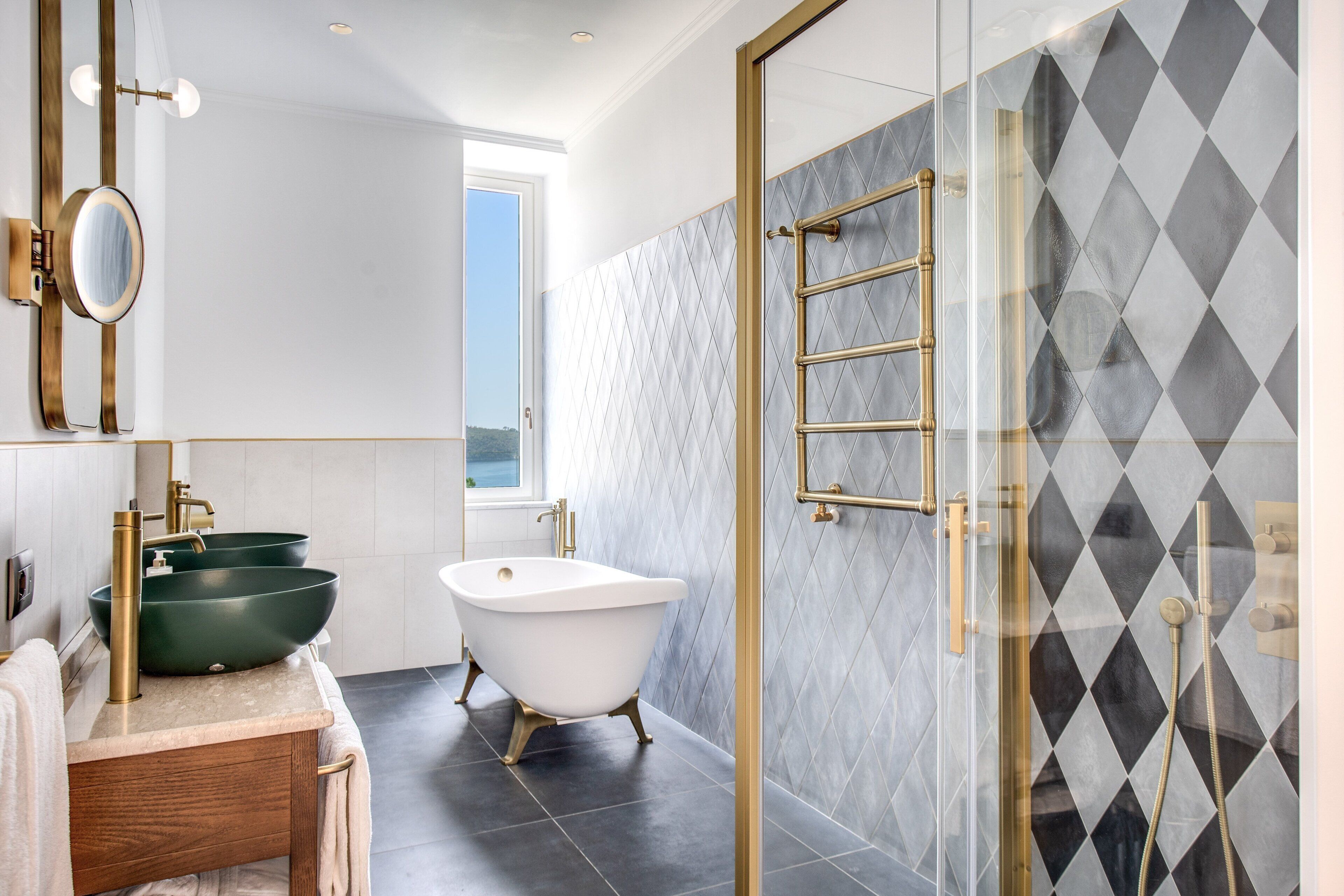 A bathroom with a freestanding bathtub, a large vessel sink, and a glass-enclosed shower area.