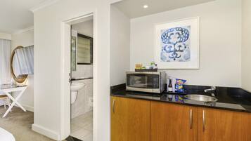 A modern kitchen with a microwave, sink, and countertop.