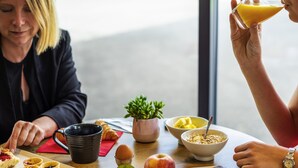 A breakfast setting with a plate of food, a cup, and a bowl. - ibis Nuits Saint Georges (Nuits-Saint-Georges)