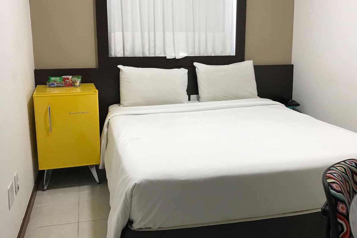 Economy Double Room | Minibar, in-room safe, desk, blackout drapes