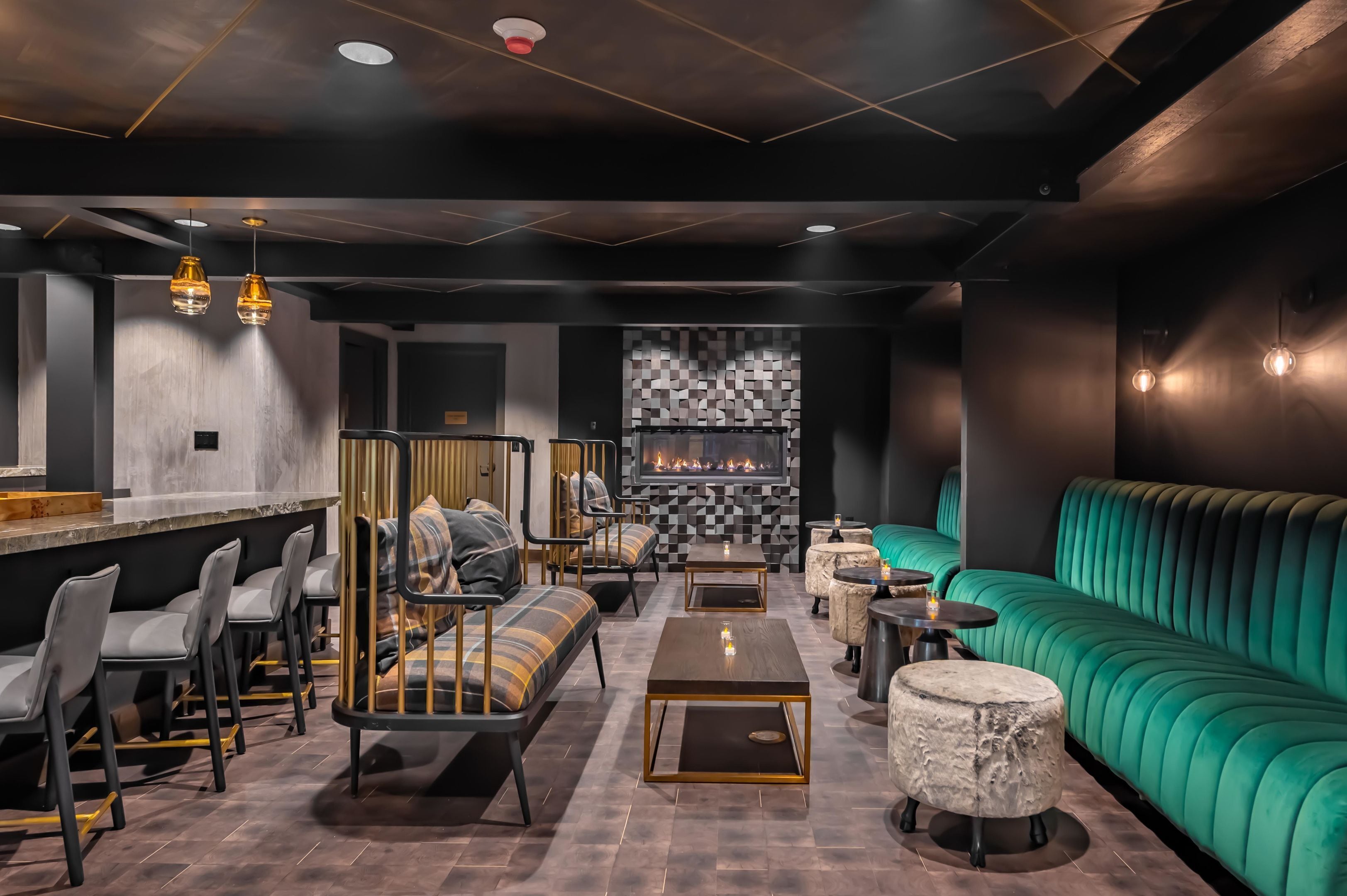 Un espace de détente moderne avec des sièges, un bar et une cheminée.