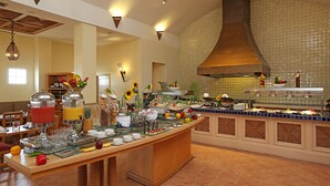 A buffet with various food items and a large central island. - Four Points by Sheraton Santo Domingo (Boca Chica)