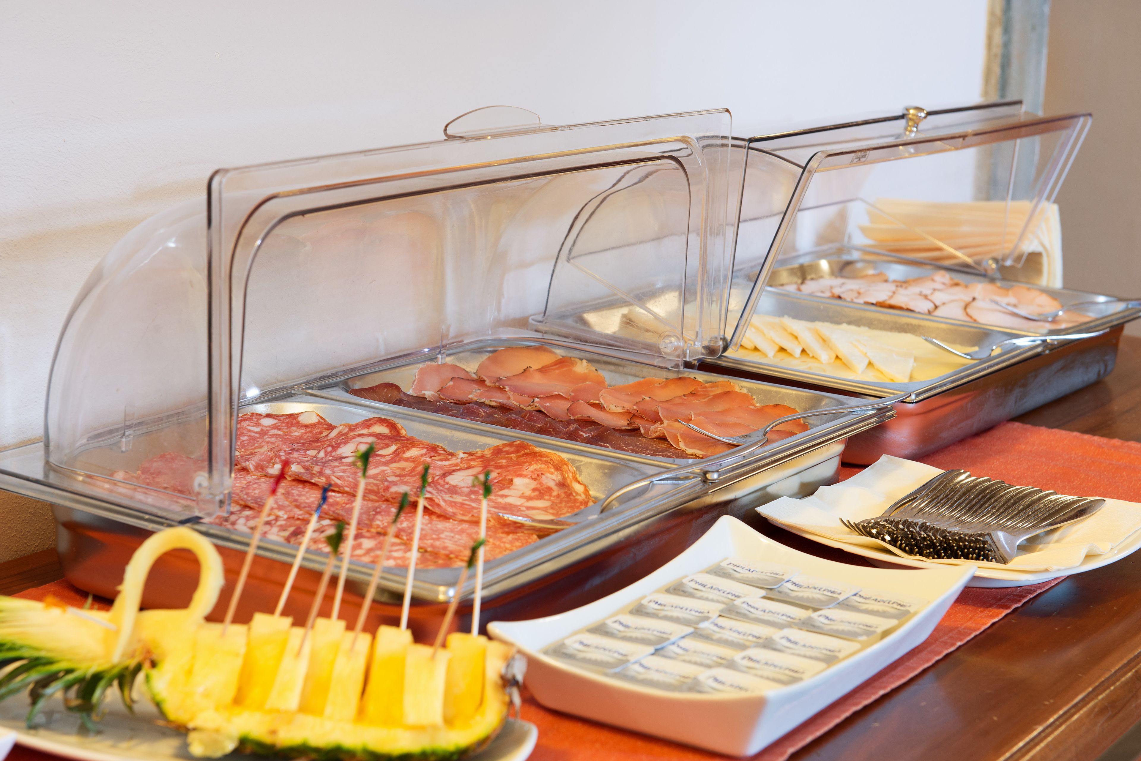 Un buffet proposant une variété de viandes, de fromages et de fruits.