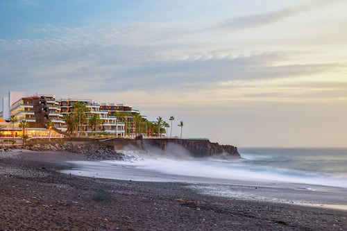 On the beach, black sand